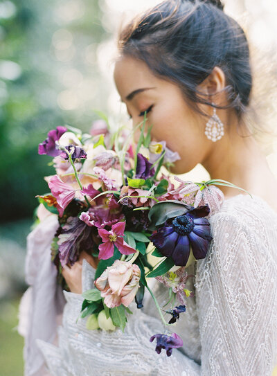 bride smelling spring floral bouquet