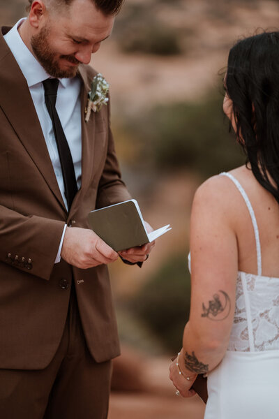 bride and groom exchanging vows in the desert