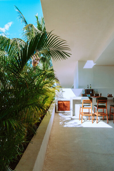 View of a kitchen from a balcony with palm trees in the background