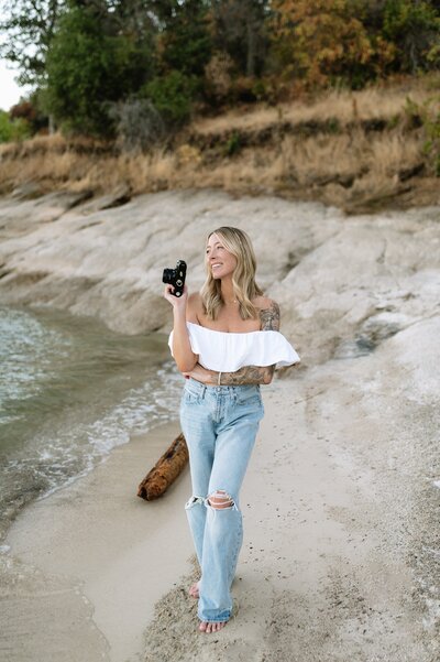 photographer holding camera on beach