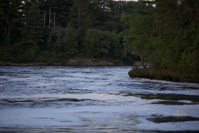 Flowing water along a rock shore below The Wisconsin dells dam