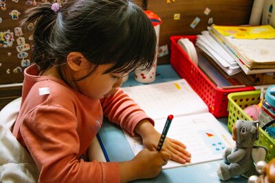 A young Indigenous girl completing school work