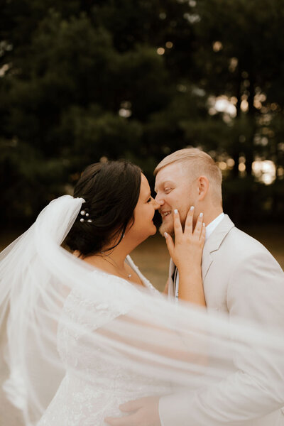 bride and groom embrace at wedding in peoria illinois