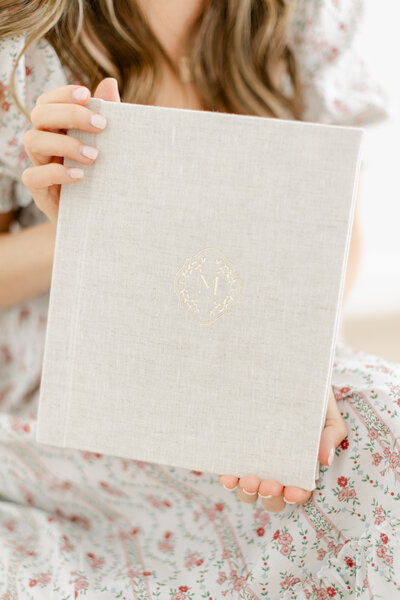 prints from South Jersey newborn photography session laid out across bed