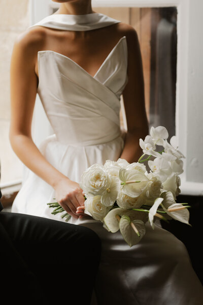 Bride holding bouquet in France on her wedding day taken by Lindsey Roman Photography