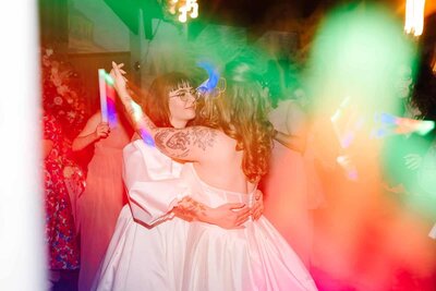 Two  brides dancing at wedding reception 