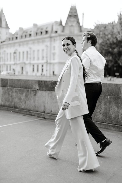 Man and Woman, guests in a wedding, walking towards the ceremony location in Paris France