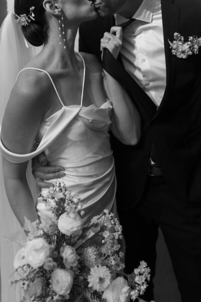 Couple kissing on wedding day