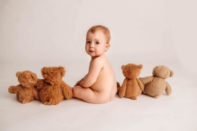Baby peers into the camera during Studio Portrait Session in Charleston, SC.