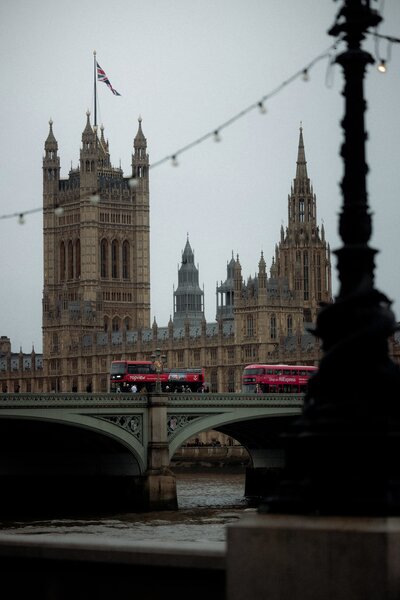 View of  Westminster bridge and lonodn iconic double ducker buses with Houses of parlimant and BigBen in the background
