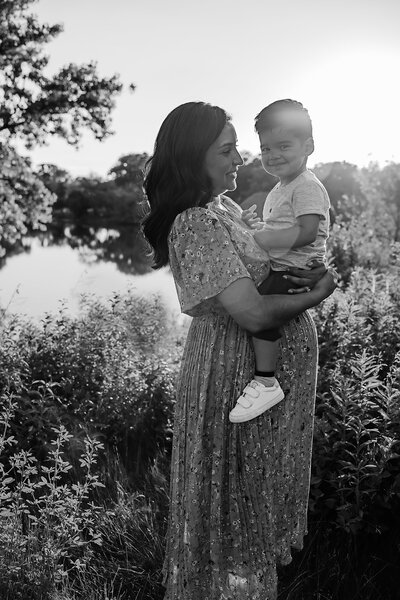 Pregnant mom holding oldest son in maternity session photo by Taylor Lynn Studios