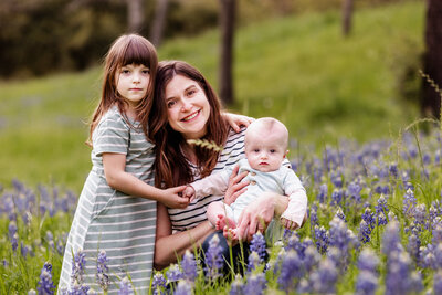 A family picture in a bluebonnet field