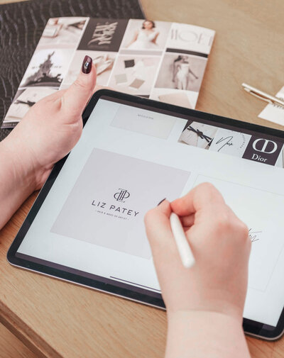 Sarah Shuttle designing a luxury beauty brand at her desk, with iPad and mood board in view.