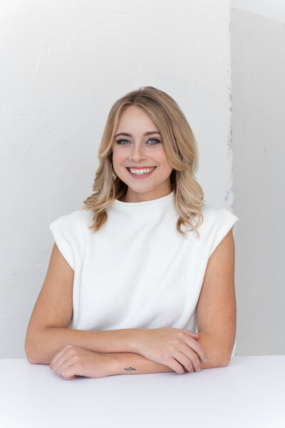 Portrait of Maddee Rodewald, Design Associate at Norton Interiors, smiling and wearing a light blue blouse