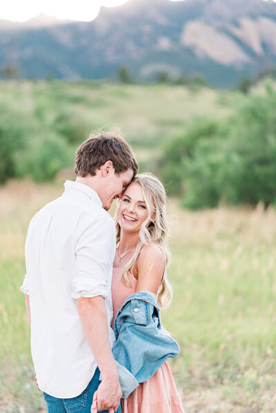 bride and groom dance together at their reception smiling at each other and having a good time