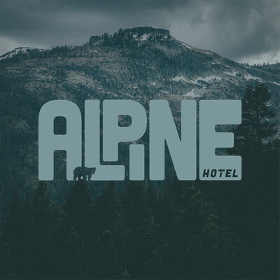 Alpine Hotel branding shown with a background image of a mountain.