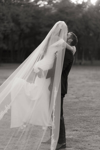 A bride and groom exploring a canyon desert landscape