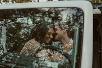 couple snuggling in a jeep
