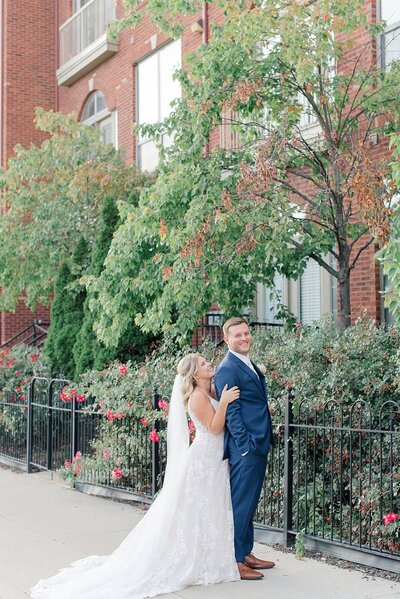 bride smiling at groom during sunset pictures outside the the vue venue taken by ashleigh grzybowski a columbus wedding photographer