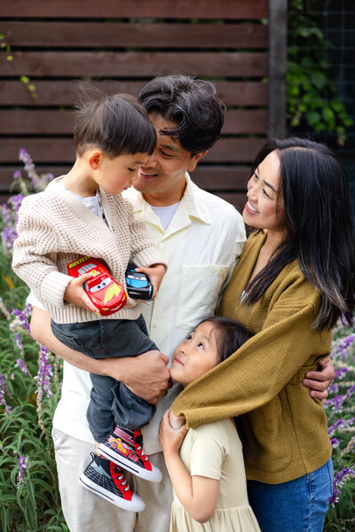 Family of four sharing a joyful moment in a garden setting – Bay Area Family Portfolio - Ellobelle Photography Family Photographer