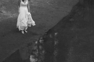 Oregon bride dipping toes in ocean at sunset