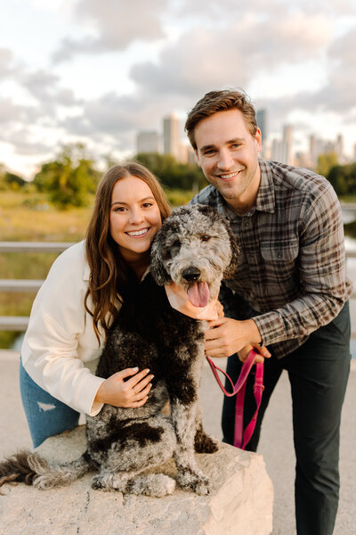 Newly engaged couple posing with their dog in Chicago