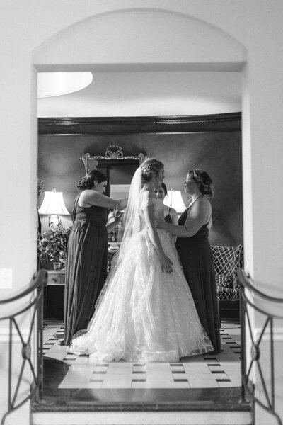 bridesmaids bustle brides wedding dress before reception entrance