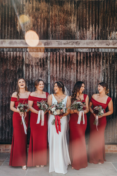 bride laughs with her bridesmaids
