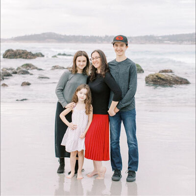 photograph of bay area photographers and her three children on the beach in Marin County