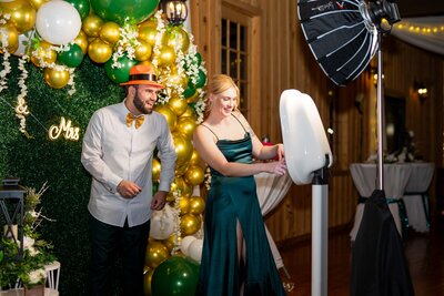 A Bridesmaid and groomsman using the Dallas Fort WOrth Photo Booth at a wedding.