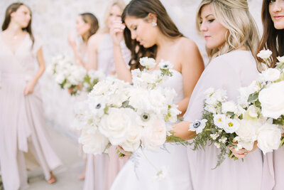 Candid photo of a bride and her bridesmaids holding bouquets