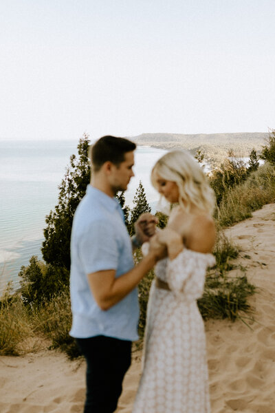Couple holding hands at Empire Bluff Trail in Northern Michigan