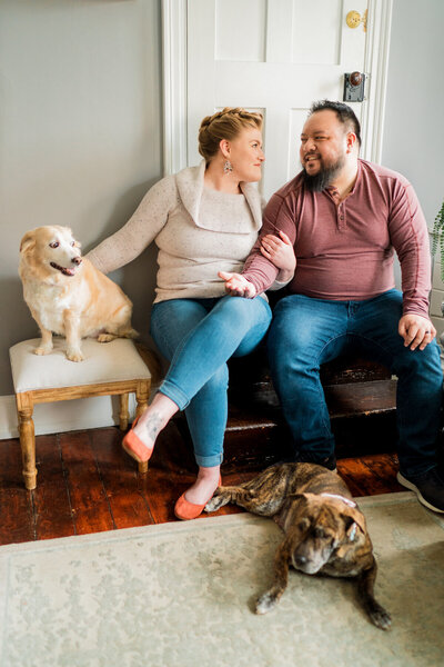 Phil and Rebecca Mai sitting with their dogs Macy and Dori