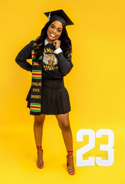 a college senior posing in school spirit attire