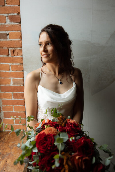 bride poses with bouquet after wedding ceremony in lancaster pa