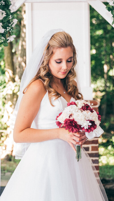 Bride looking at her bouquet and smiling