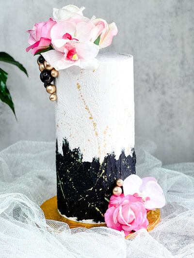 Black and white cake with pink flowers and gold accents by Artisan Buttercream custom cake bakery serving metro Detroit: birthdays, weddings & more!