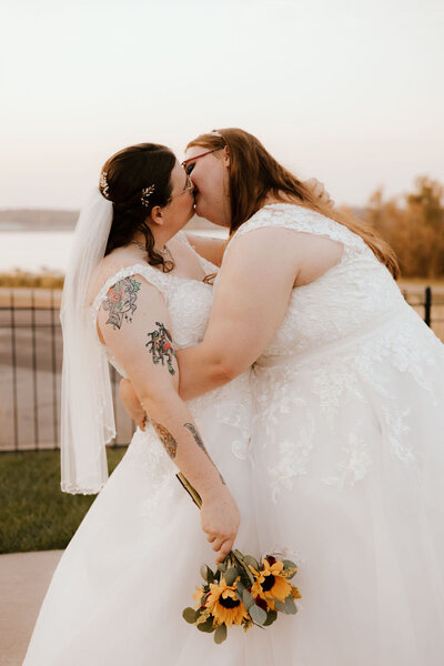 wedding couple share a kiss at wedding in peoria illinois