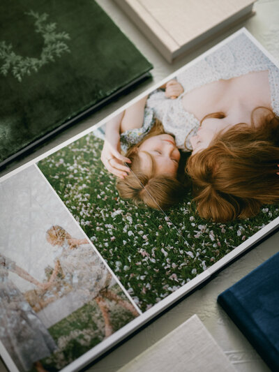 mother and daughter laying in flower petals at huntsville alabama photography session by fauna & film