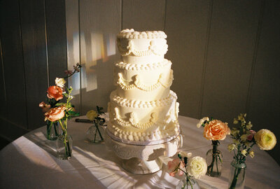 flash photo of a cute wedding cake with a neon sign backdrop during a texas wedding day