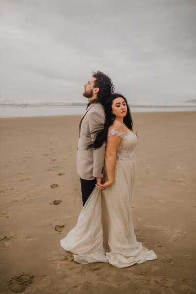 couple embracing on beach on oregon coast
