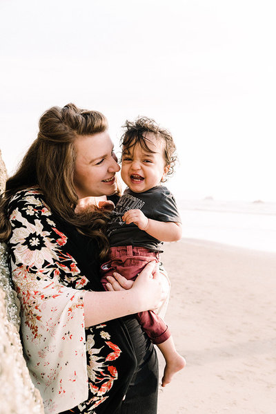 mother laughing with son at Oregon coast photo credit Posy Quarterman