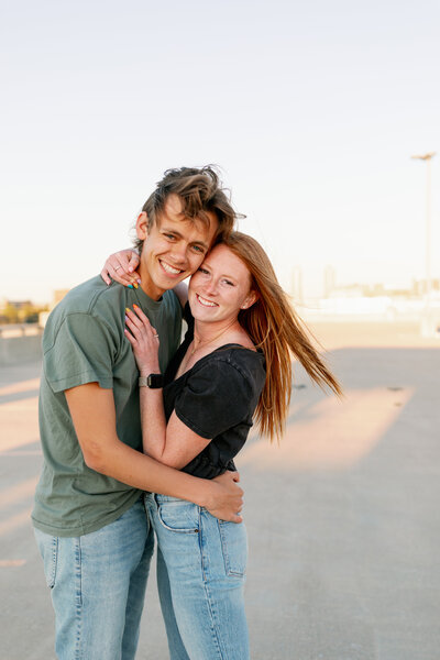 couple standing on parking garage rooftop