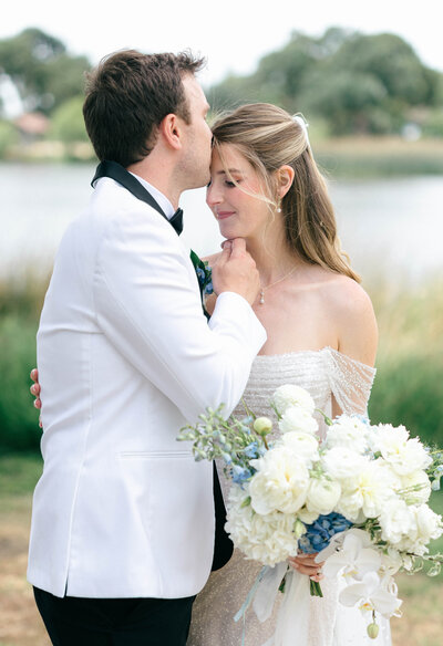 Bay Area Wedding Photographer, groom tilting bride's head down and kissing her forehead