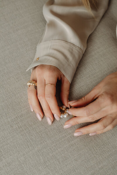 kaboompics_details-of-gold-jewelry-beautiful-woman-wearing-a-tan-silk-shirt-28092