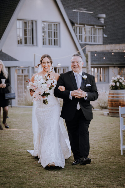 Bride walking down the aisle with her very proud dad 