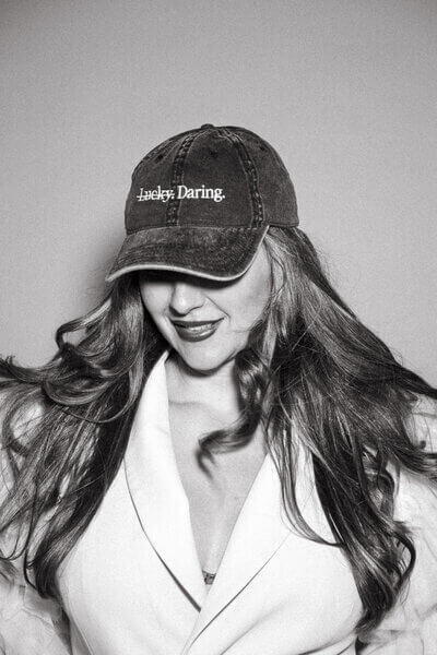 Sasha wearing baseball cap that says  Daring