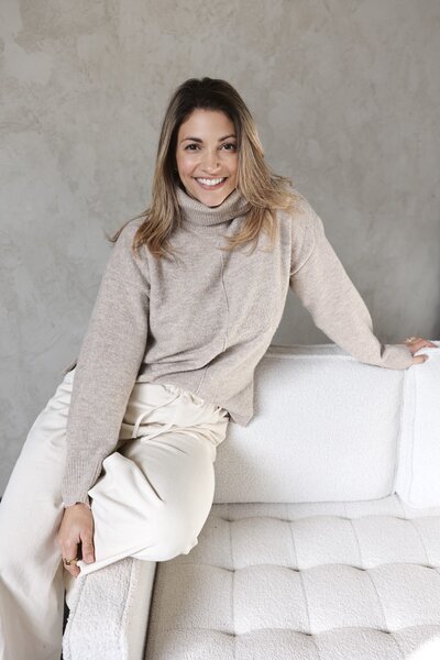 woman smiling in on sofa