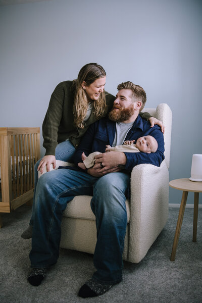 Parents with their newborn baby in their nursery in Pittsburgh. 
