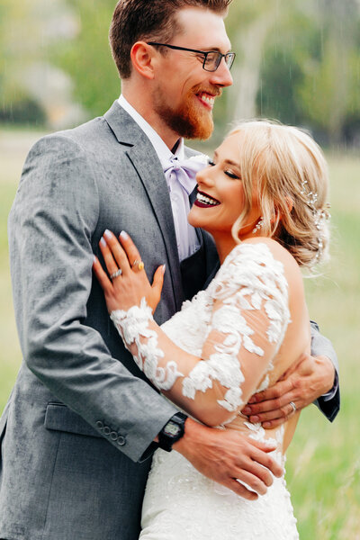 Missoula bride and groom embracing in rain at Ten Spoon Winery